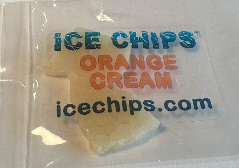  Ice chips in clear plastic packaging with printed branding reading 'ICE CHIPS', 'ORANGE CREAM', and 'icechips.com'.