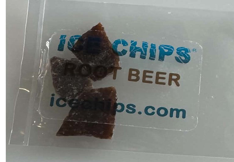 A clear plastic bag containing a square white label printed with 'ICE CHIPS ROOT BEER' in blue and brown lettering, plus 'icechips.com'.
