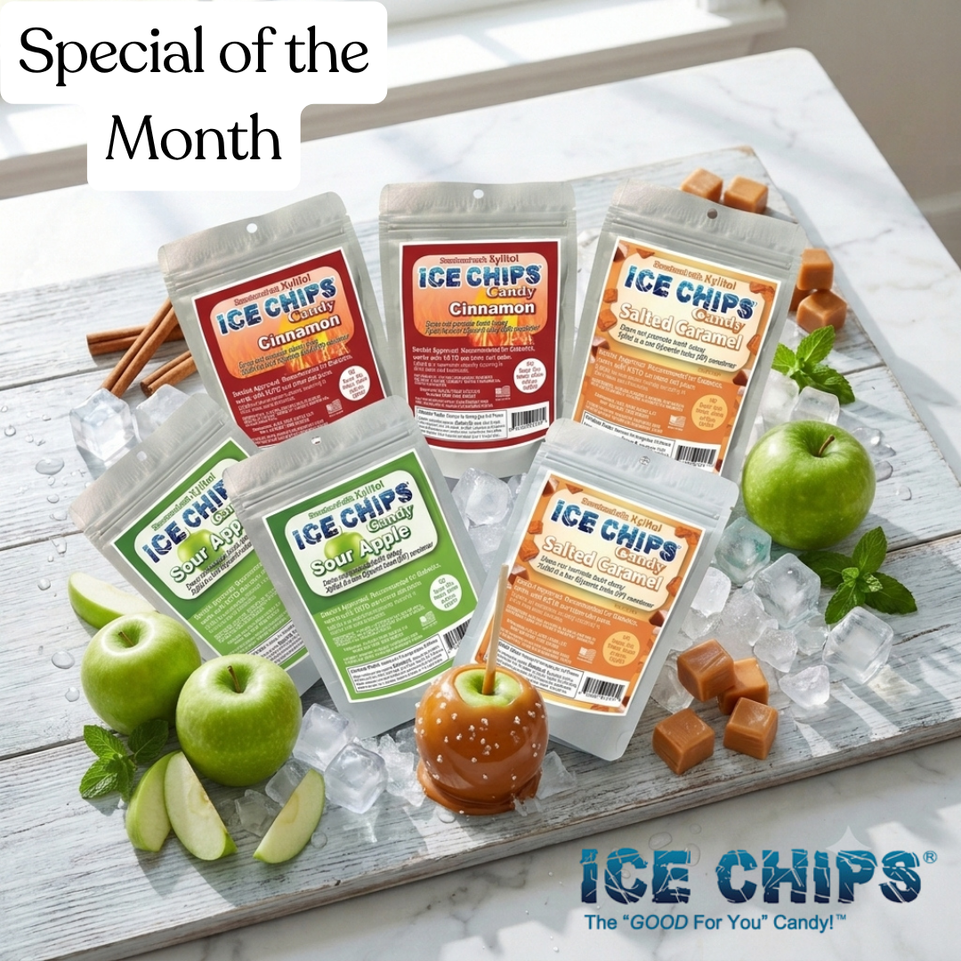 Six bags of Ice Chips candy in assorted flavors arranged on a white wooden board with ice, green apples, mint, and caramel pieces. The packages show flavors including Cinnamon, Sour Apple, and Salted Caramel.