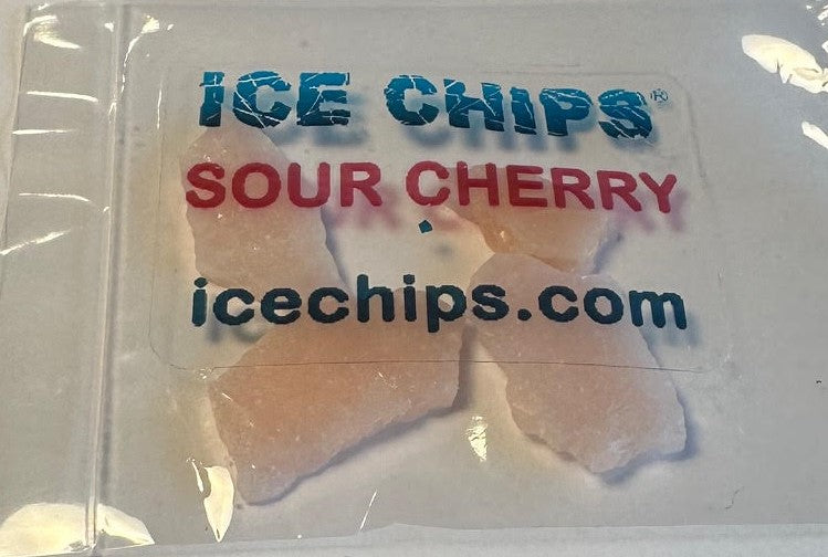 A clear plastic bag containing several translucent, ice-like candy pieces with a printed label reading 'ICE CHIPS SOUR CHERRY icechips.com' in blue and red text.