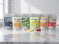 Six stand-up pouches of ICE CHIPS candy mix in assorted flavors arranged on a marble countertop with a white subway tile backsplash. The flavors shown are Berry Mix, Orange Cream, Spearmint, Lemon, Salted Caramel, and Sour Cherry.