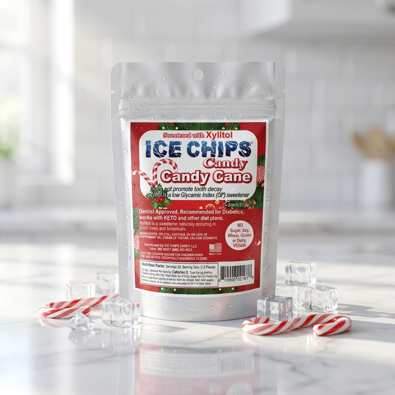 A stand-up pouch of Ice Chips Candy Candy Cane flavor, styled on a marble surface with candy canes, ice cubes, and a soft kitchen background.