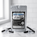 A silver resealable pouch of licorice ice chips candy stands on a glossy white surface with clear ice cubes and twisted black licorice around it. The front label reads 'ICE CHIPS Candy Licorice' and shows the brand as Sweet Tarts Approved.