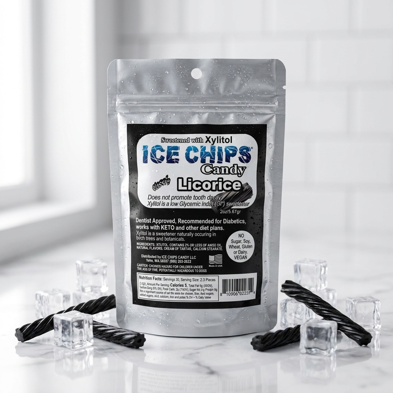 A silver resealable pouch of licorice ice chips candy stands on a glossy white surface with clear ice cubes and twisted black licorice around it. The front label reads 'ICE CHIPS Candy Licorice' and shows the brand as Sweet Tarts Approved.