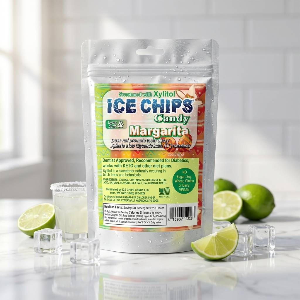 A stand-up pouch of Ice Chips Candy Margarita flavored Xylitol Candy, surrounded by lime slices, ice cubes, and a margarita glass on a marble surface with a white tiled background.
